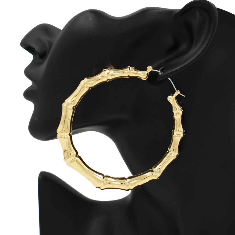 Oversized bamboo-inspired hoop earrings featuring sculpted tube detailing and a bold circular silhouette.
