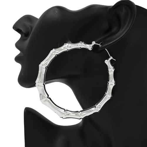 Oversized bamboo-inspired hoop earrings featuring sculpted tube detailing and a bold circular silhouette.