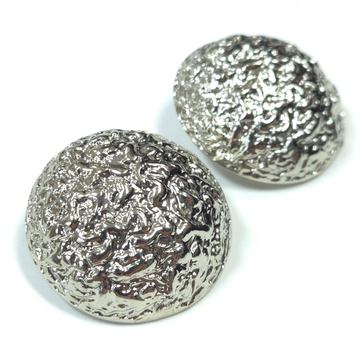 Two silver textured buttons on a white background