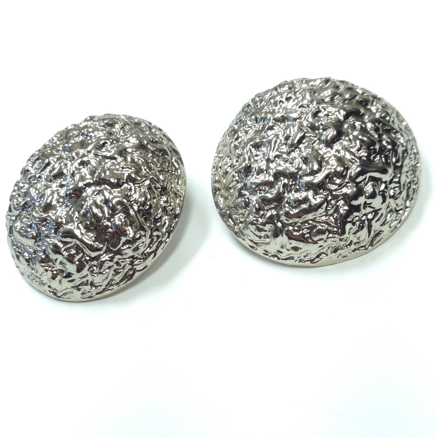 Pair of silver textured round earrings on a white background