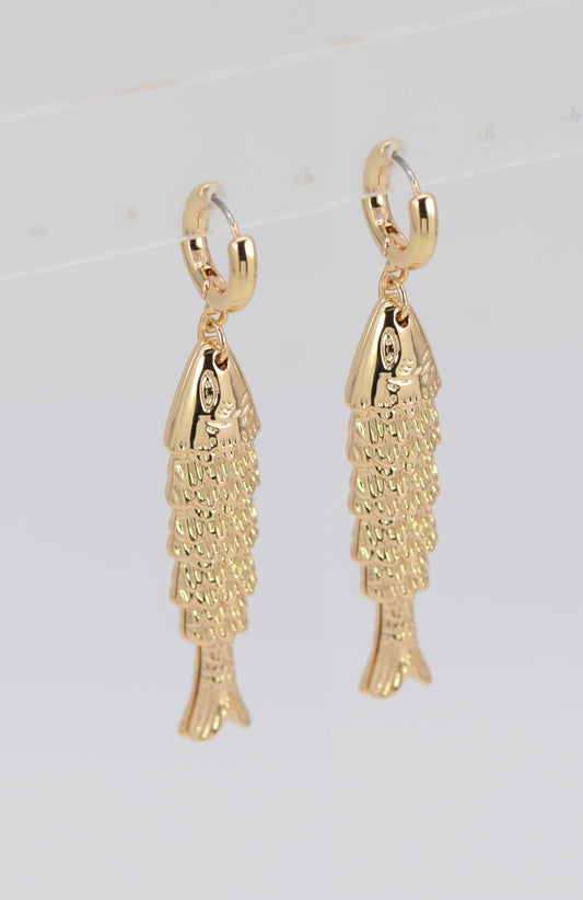 Gold fish-shaped earrings on a light gray background