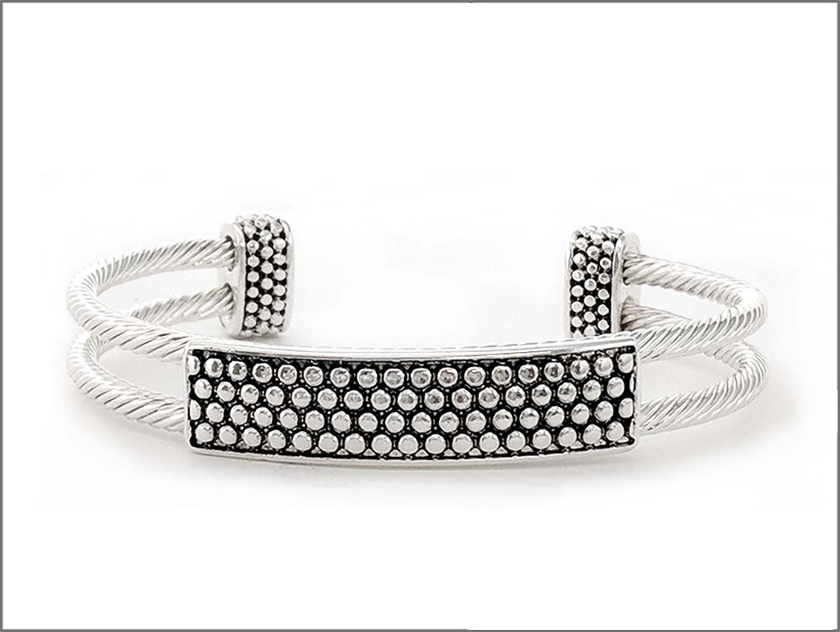 Silver-tone open cuff bracelet featuring textured twisted wire bands and a rhinestone pave bar accent.