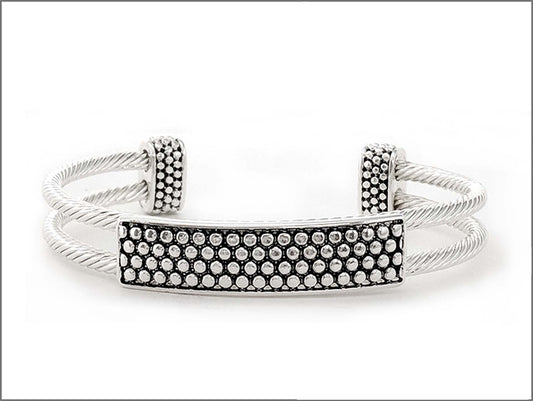 Silver-tone open cuff bracelet featuring textured twisted wire bands and a rhinestone pave bar accent.