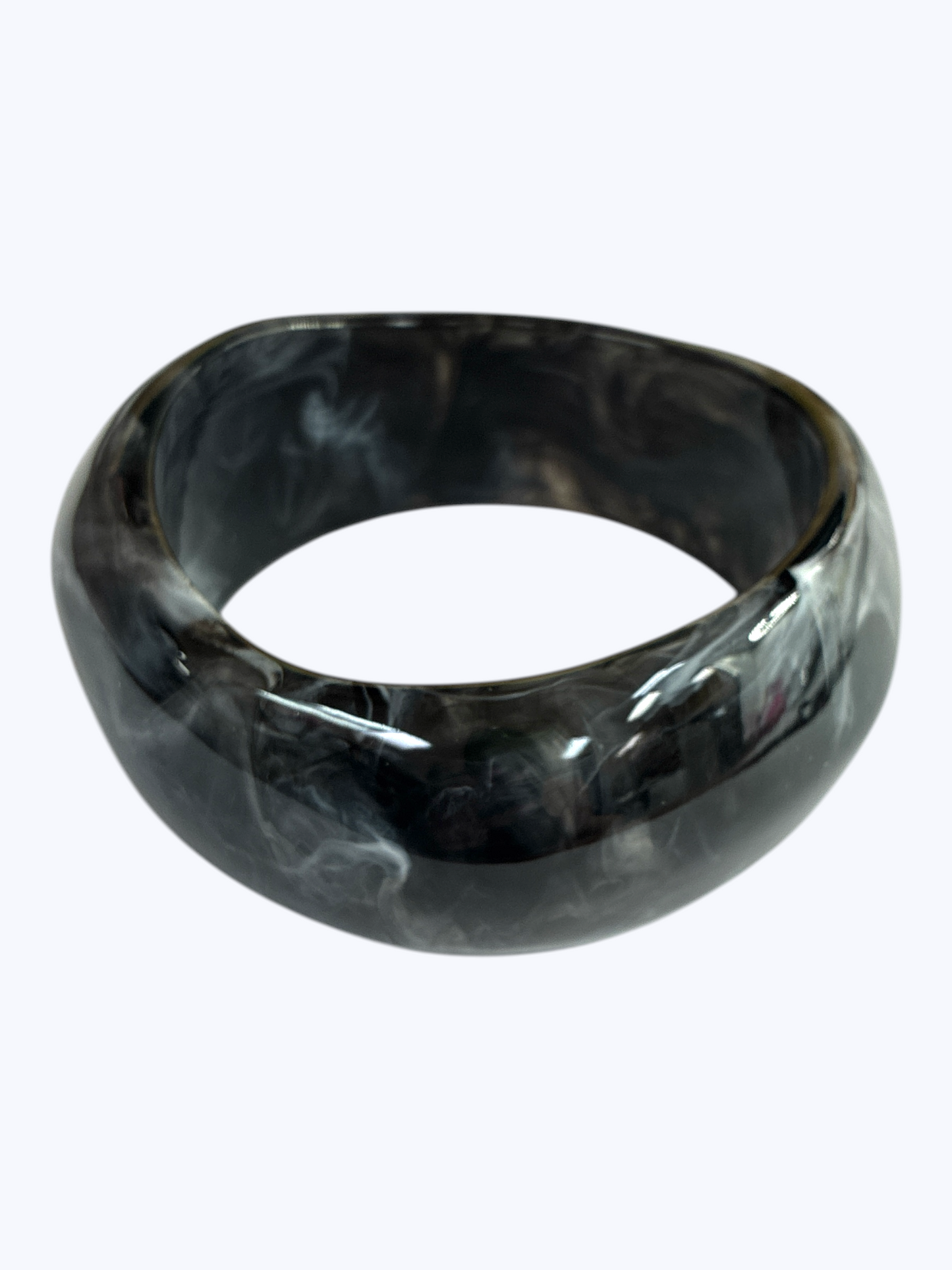 Glossy marbled resin bangle bracelet with chunky rounded silhouette and polished finish.