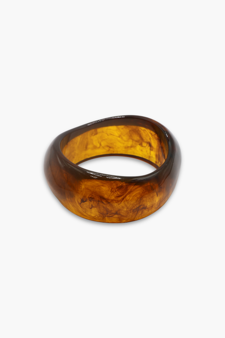 Glossy marbled resin bangle bracelet with chunky rounded silhouette and polished finish.