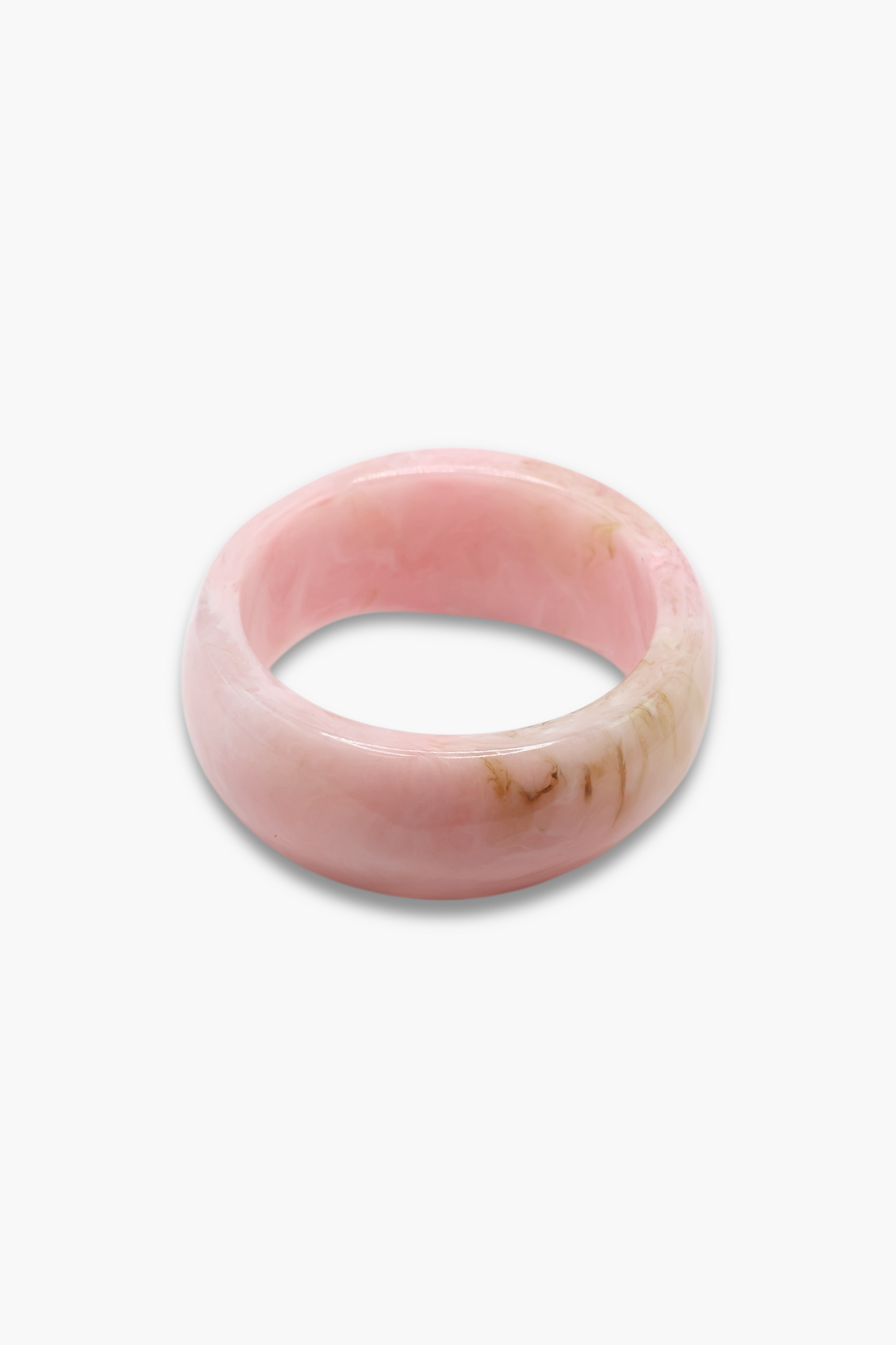 Glossy marbled resin bangle bracelet with chunky rounded silhouette and polished finish.