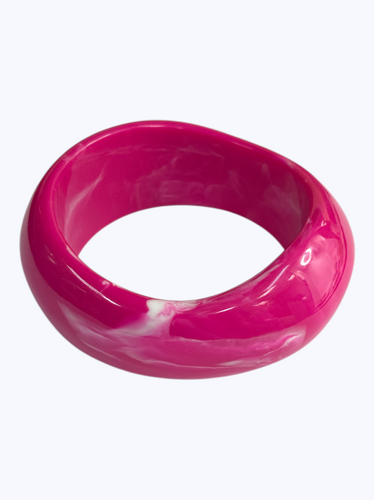 Glossy marbled resin bangle bracelet with chunky rounded silhouette and polished finish.