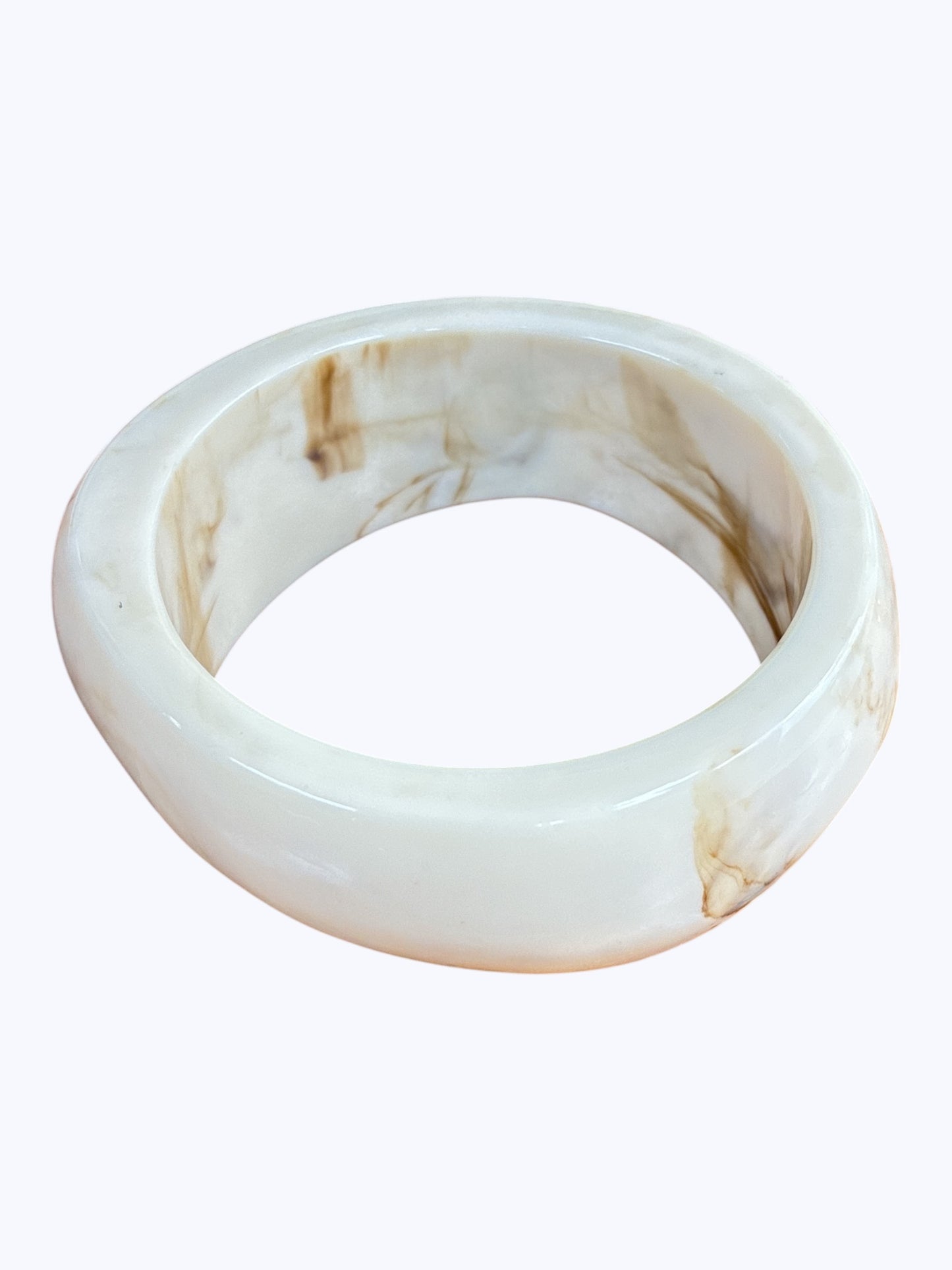 Glossy marbled resin bangle bracelet with chunky rounded silhouette and polished finish.