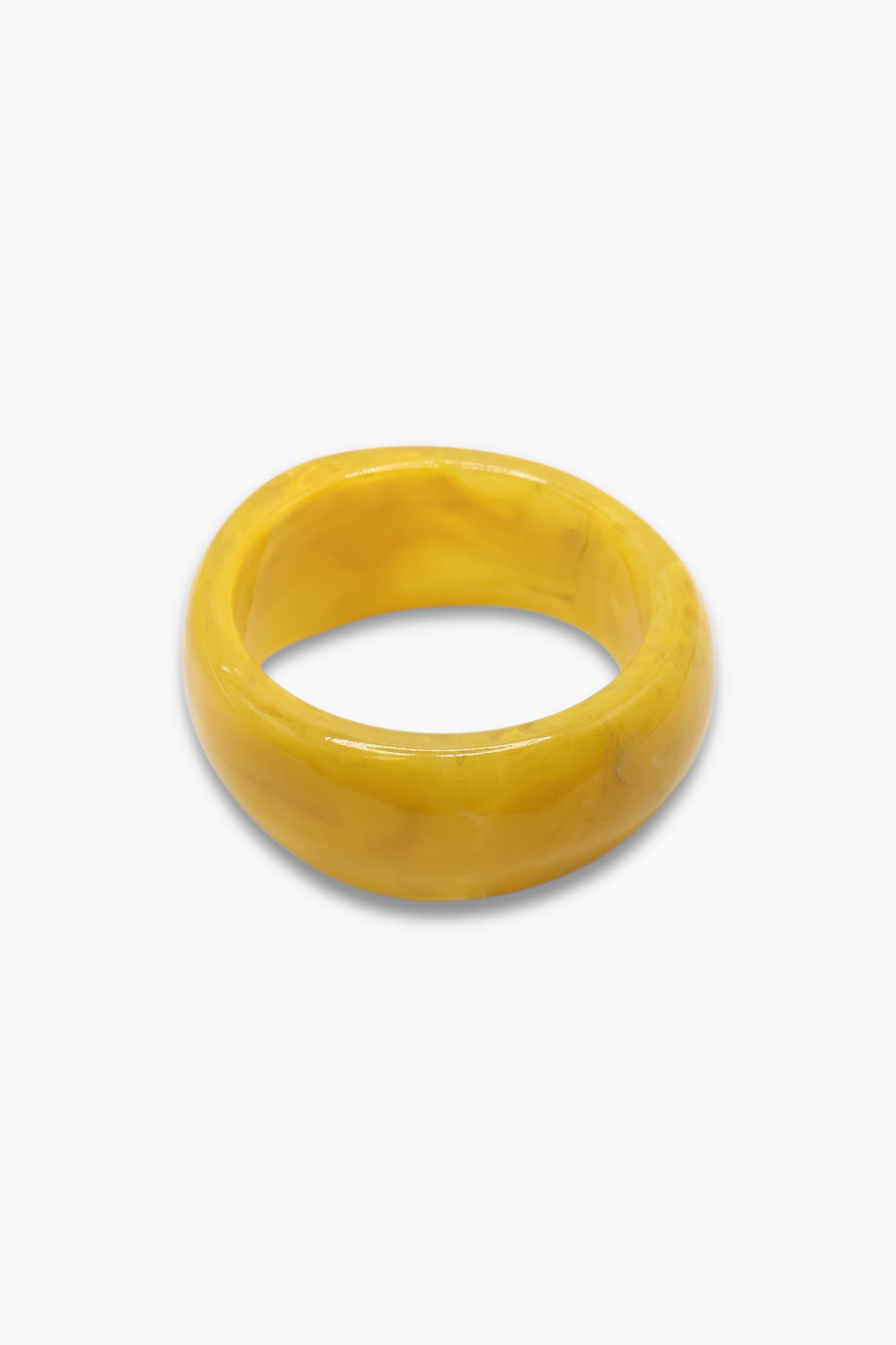 Glossy marbled resin bangle bracelet with chunky rounded silhouette and polished finish.