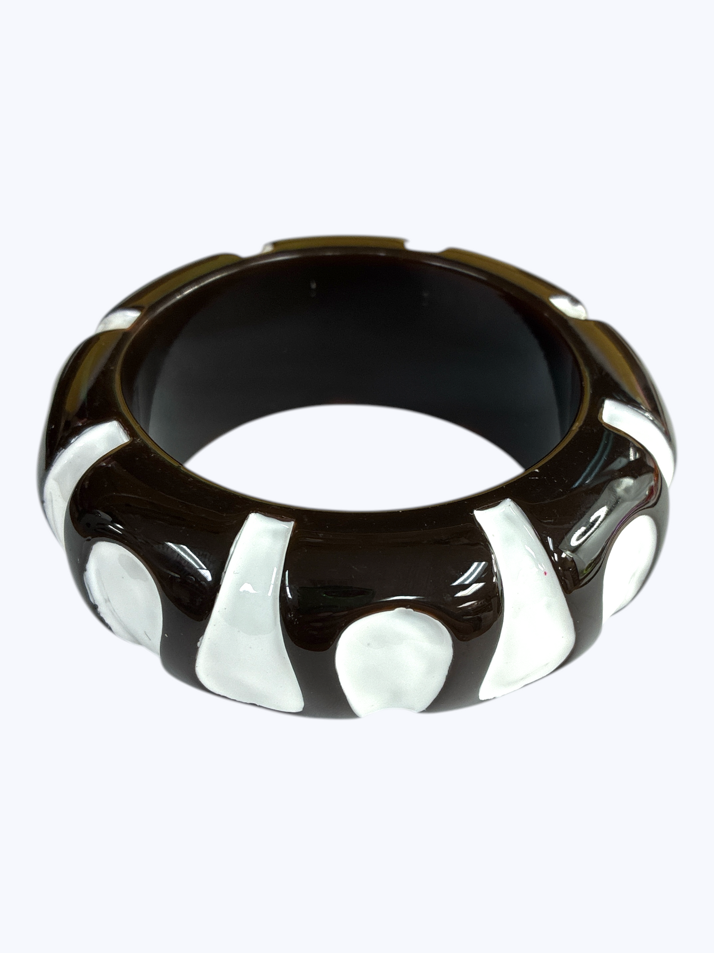 Chunky retro-inspired resin bangle bracelet with sculpted pattern detailing and glossy polished finish.