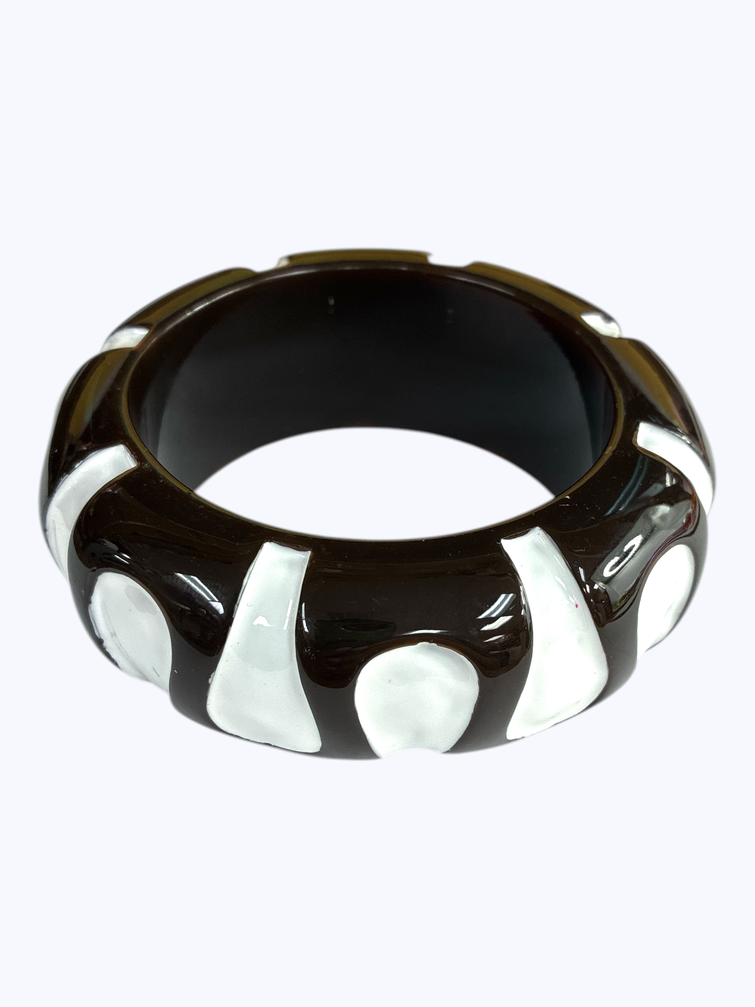 Chunky retro-inspired resin bangle bracelet with sculpted pattern detailing and glossy polished finish.