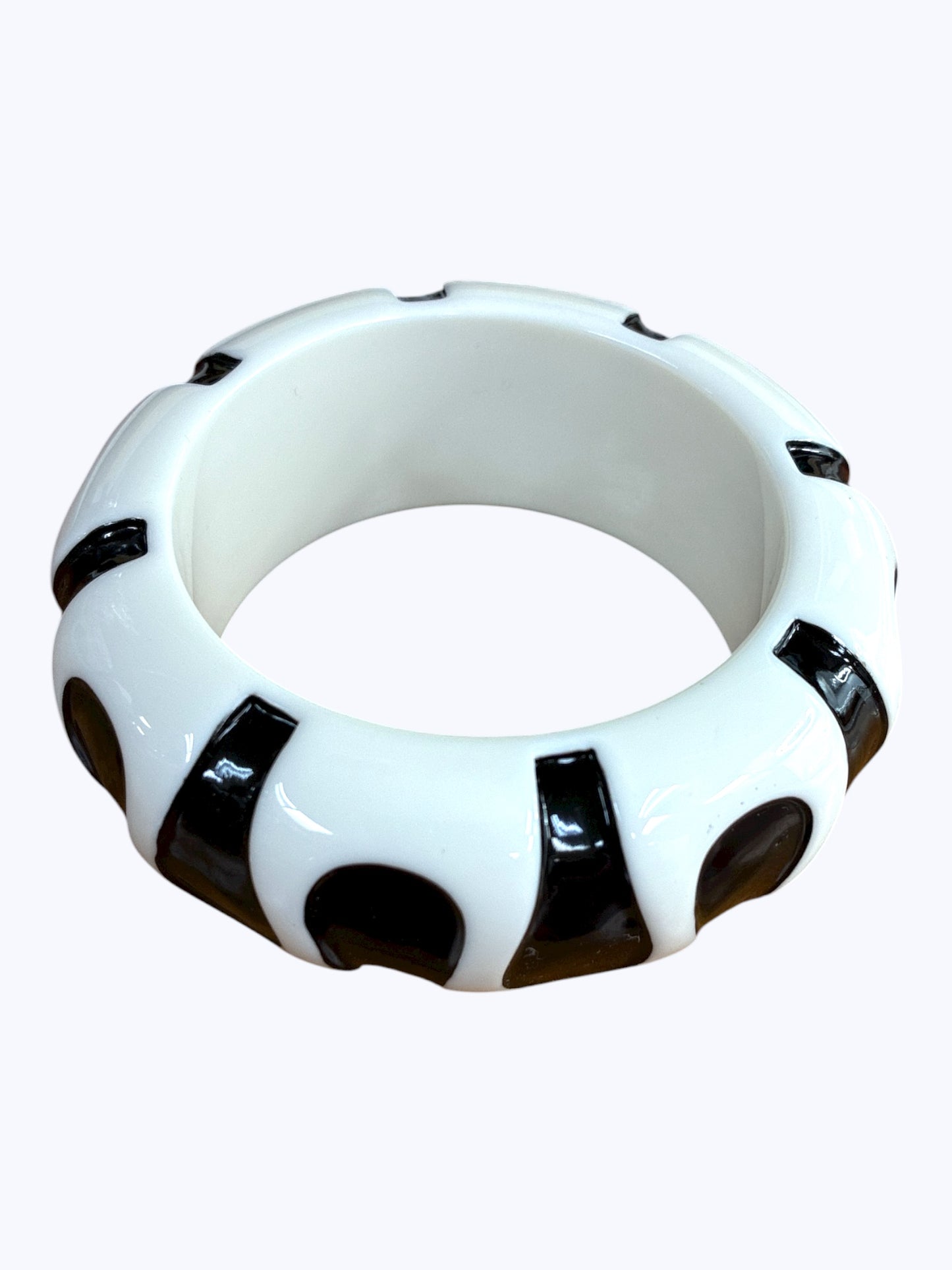 Chunky retro-inspired resin bangle bracelet with sculpted pattern detailing and glossy polished finish.