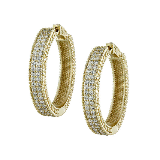 Gold hoop earrings with embedded diamonds on a white background
