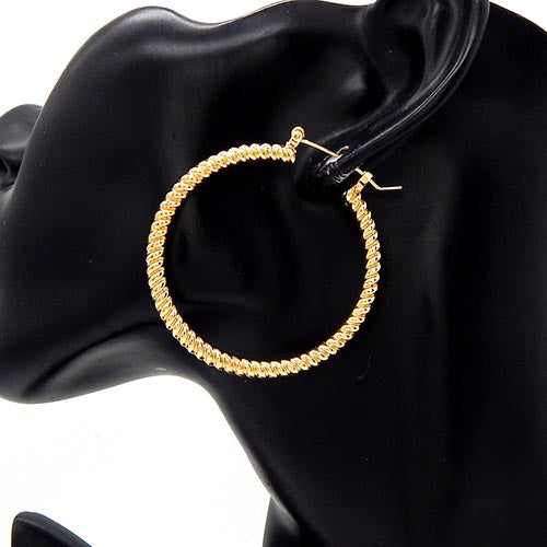 Round hoop earrings with twisted rope texture on a mannequin ear display