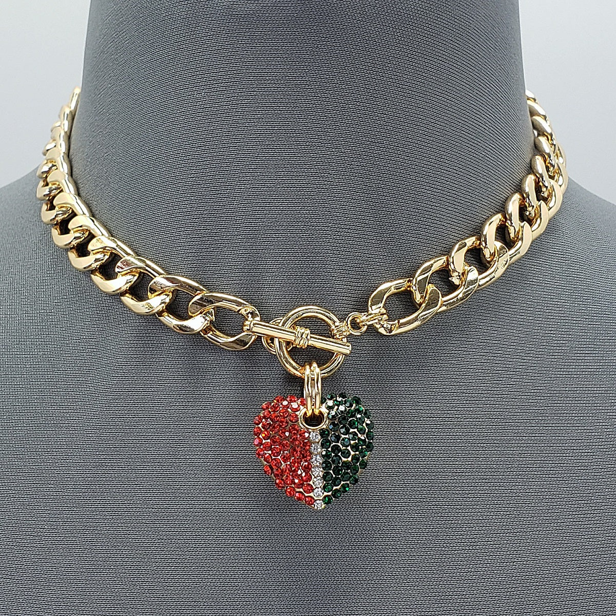Gold chain necklace with a heart-shaped charm on a mannequin bust.