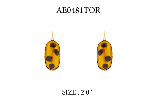 Yellow earrings with black dots on a white background