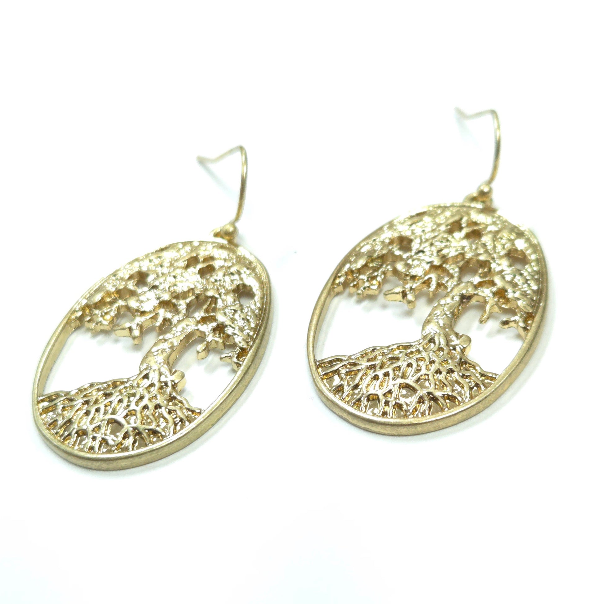 Gold tree-shaped earrings on a white background