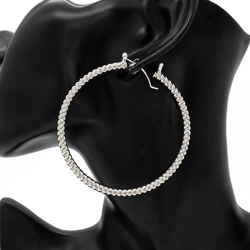 Large textured hoop earrings with twisted rope design on a mannequin ear display