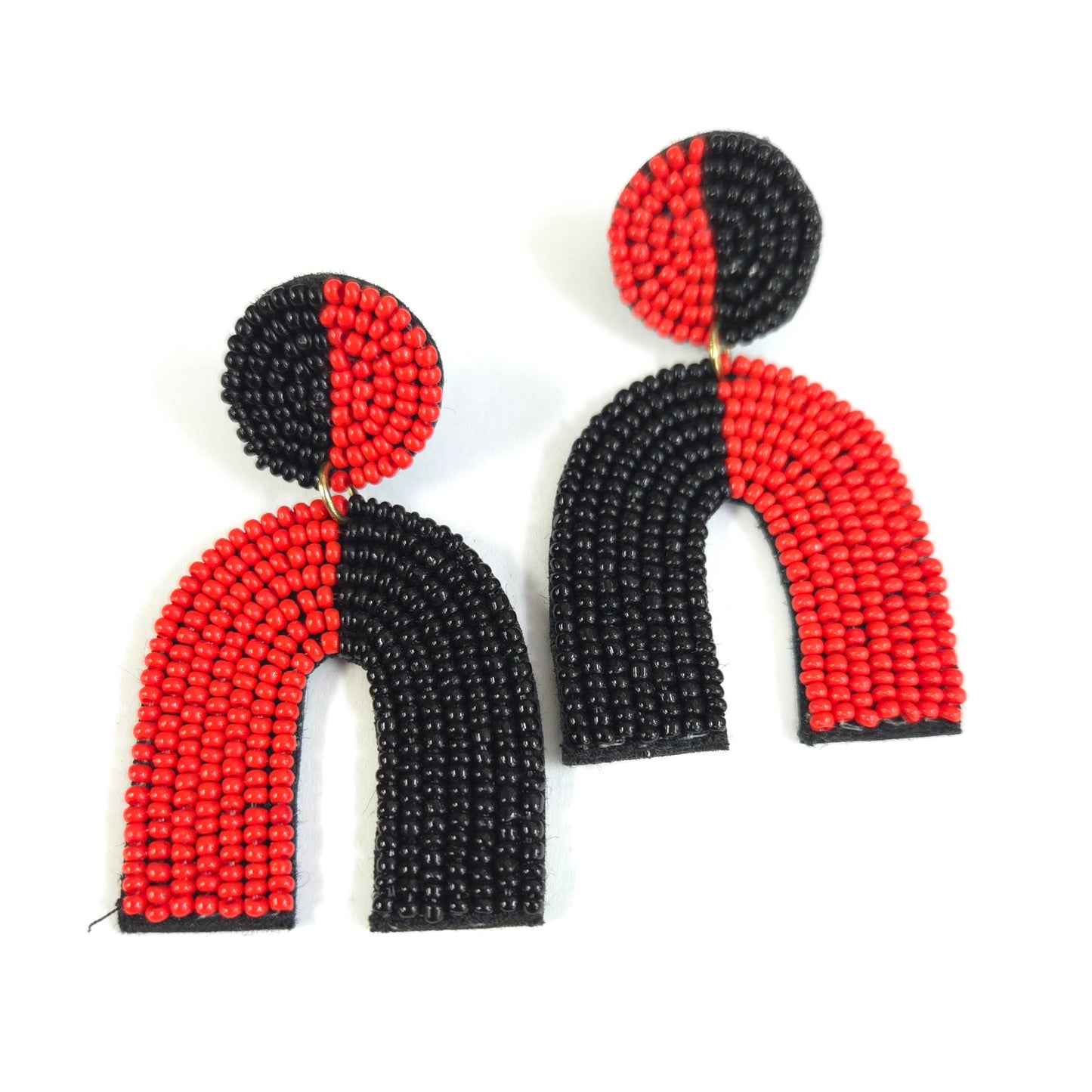 Pair of beaded earrings with black and red design on a white background