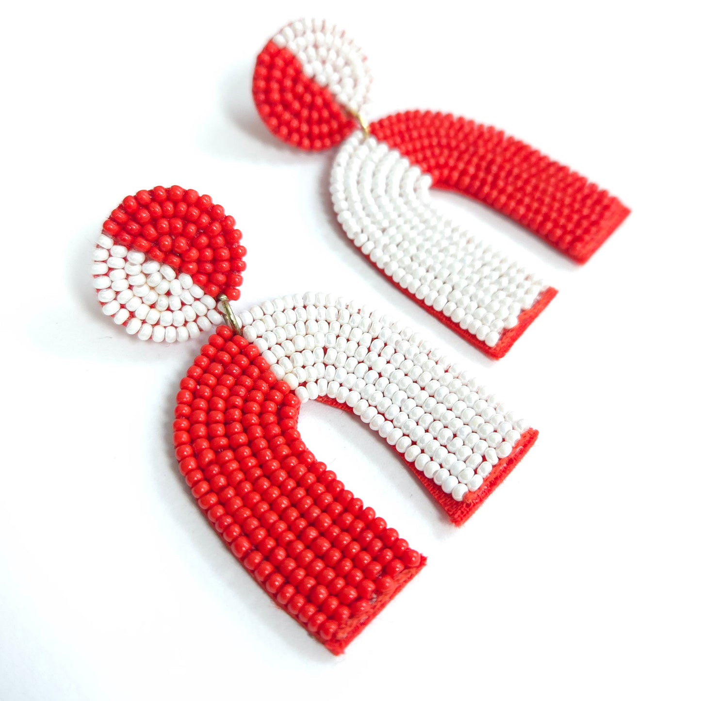 Red and white beaded earrings on a white background