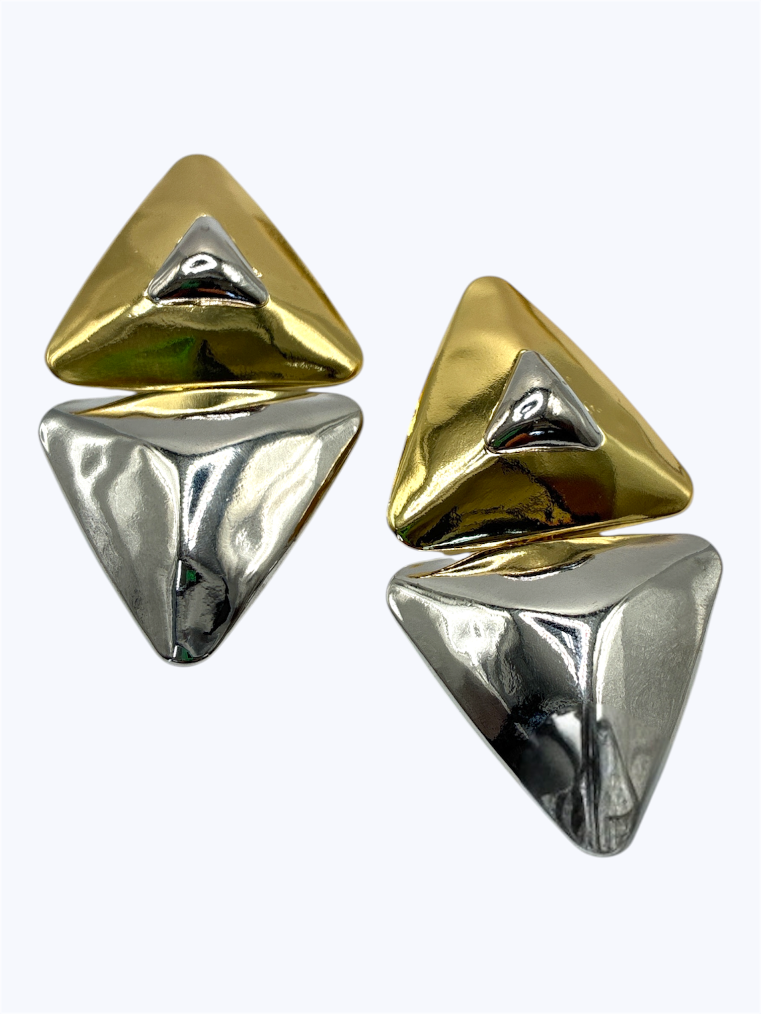 Pair of gold and silver triangle-shaped earrings on a white background