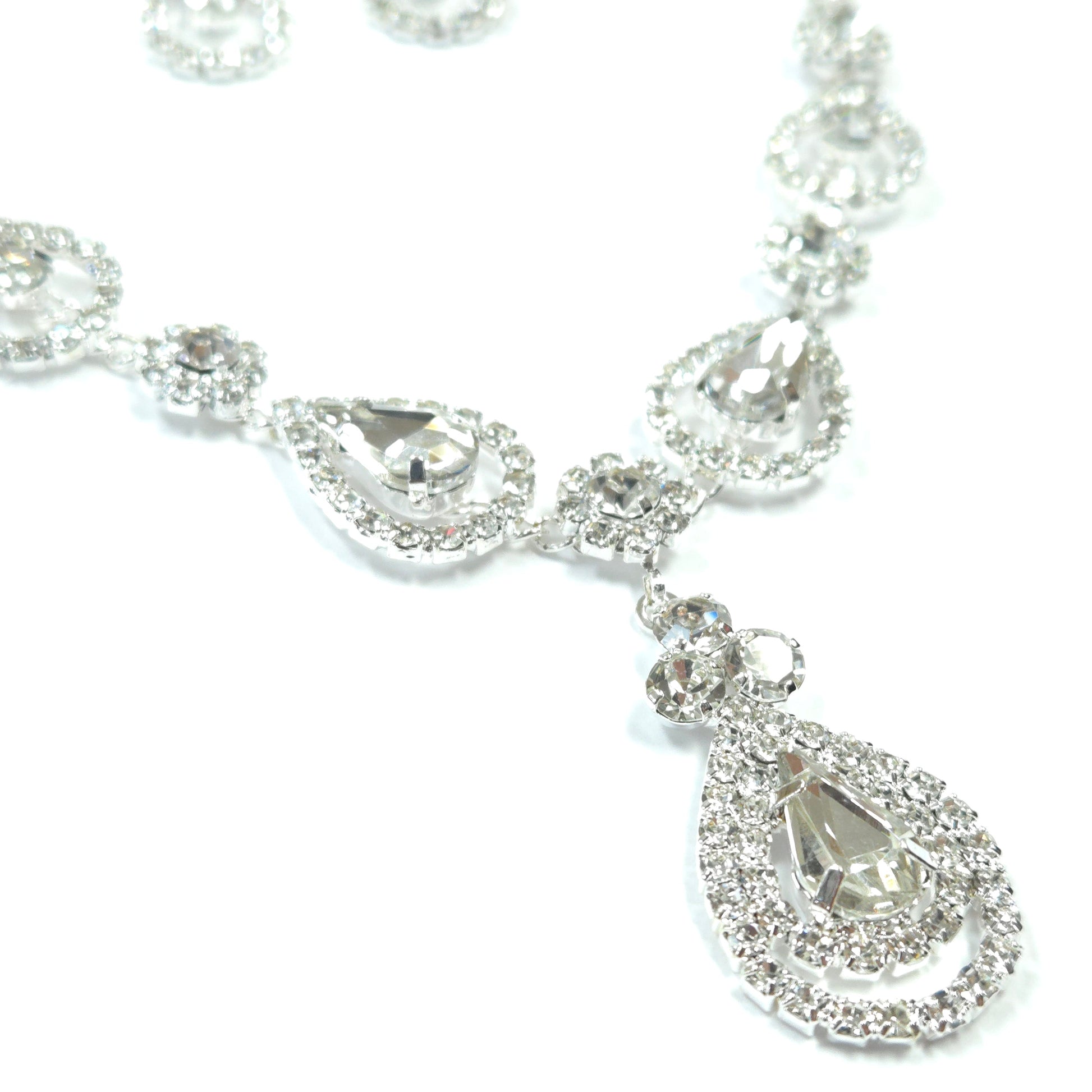 Silver bracelet with clear gemstones on a white background