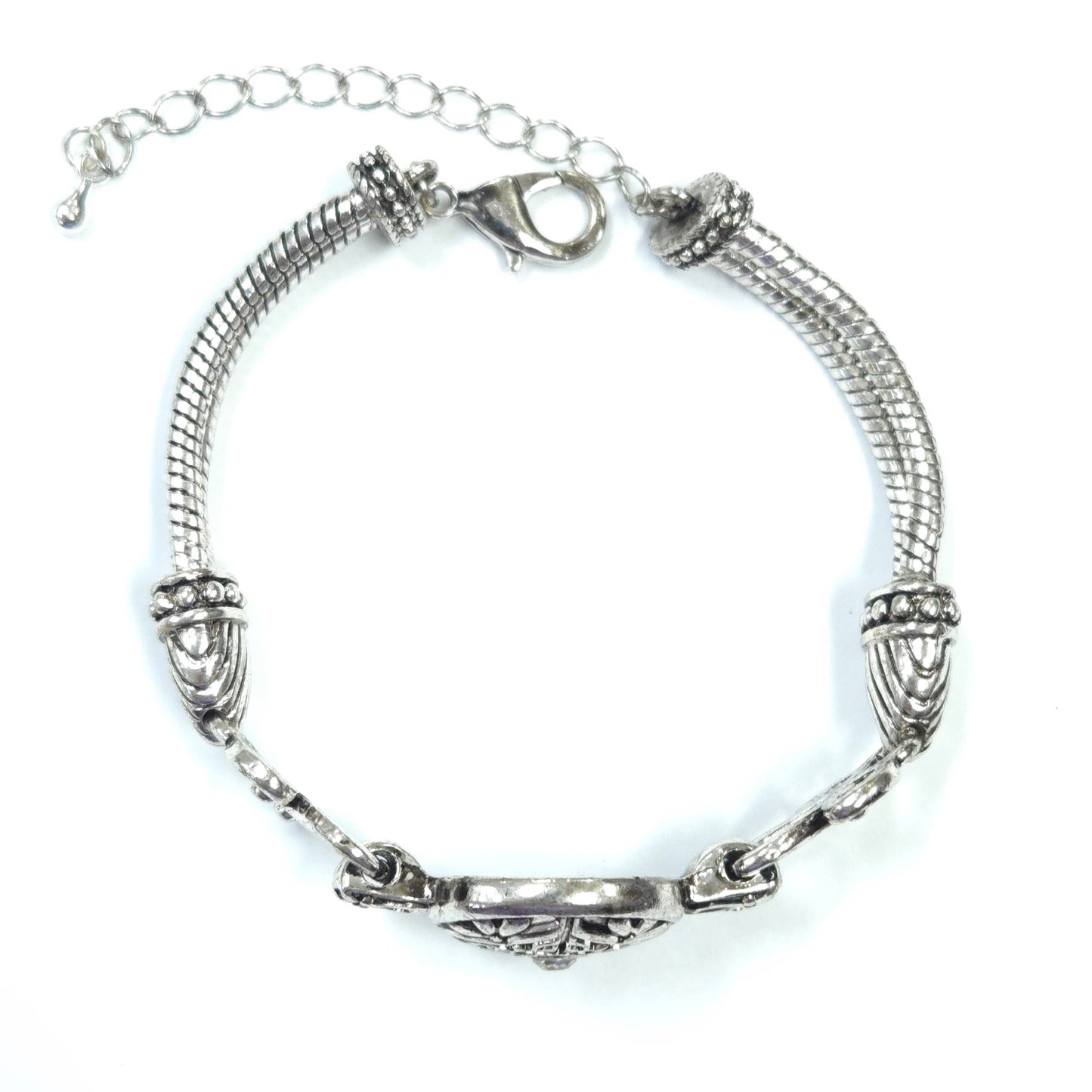 Silver bracelet with intricate design on a white background