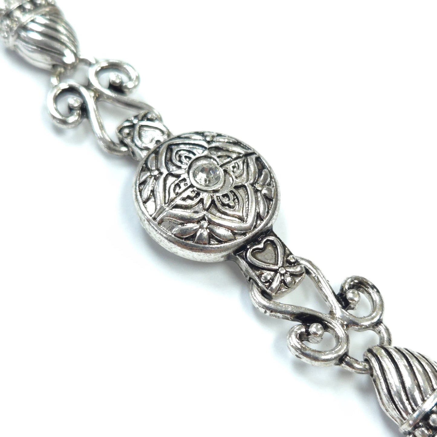 Silver bracelet with intricate designs on a white background