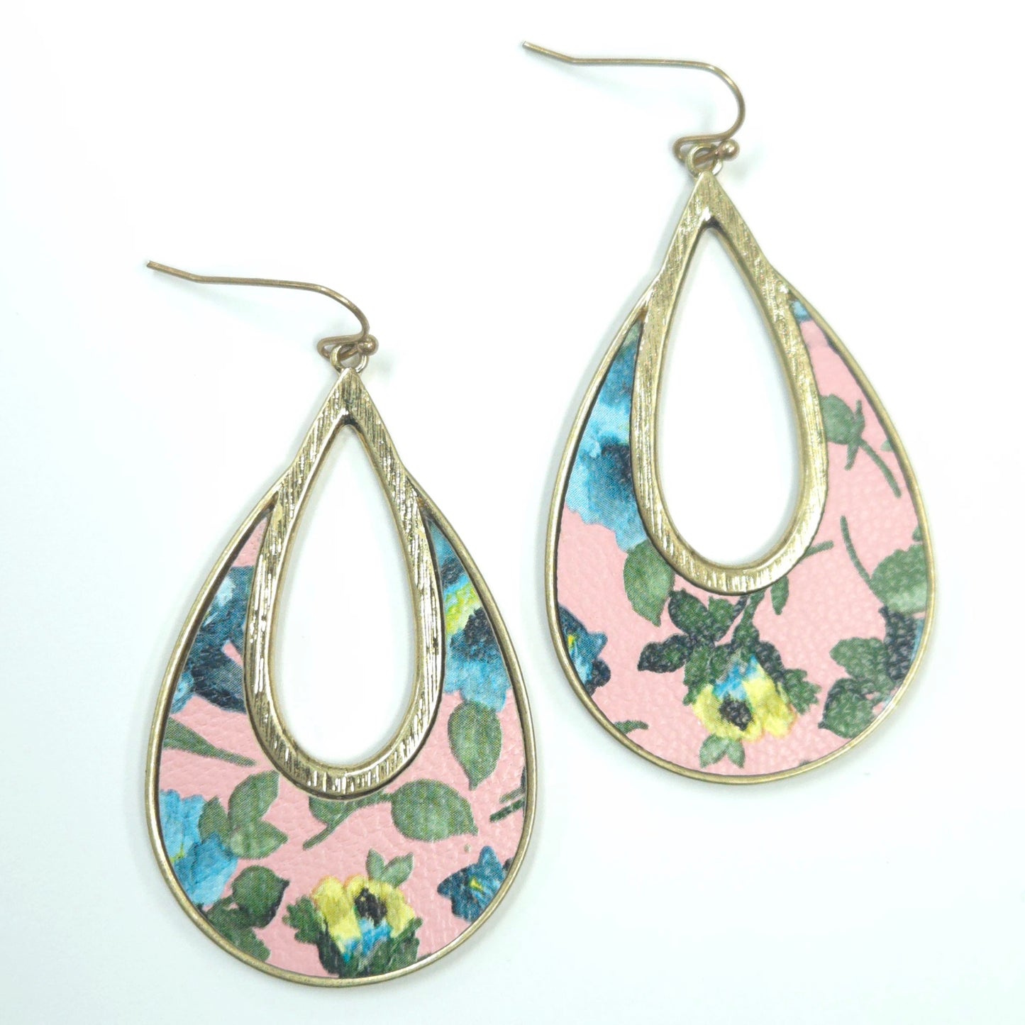 Teardrop-shaped earrings with floral pattern on a white background