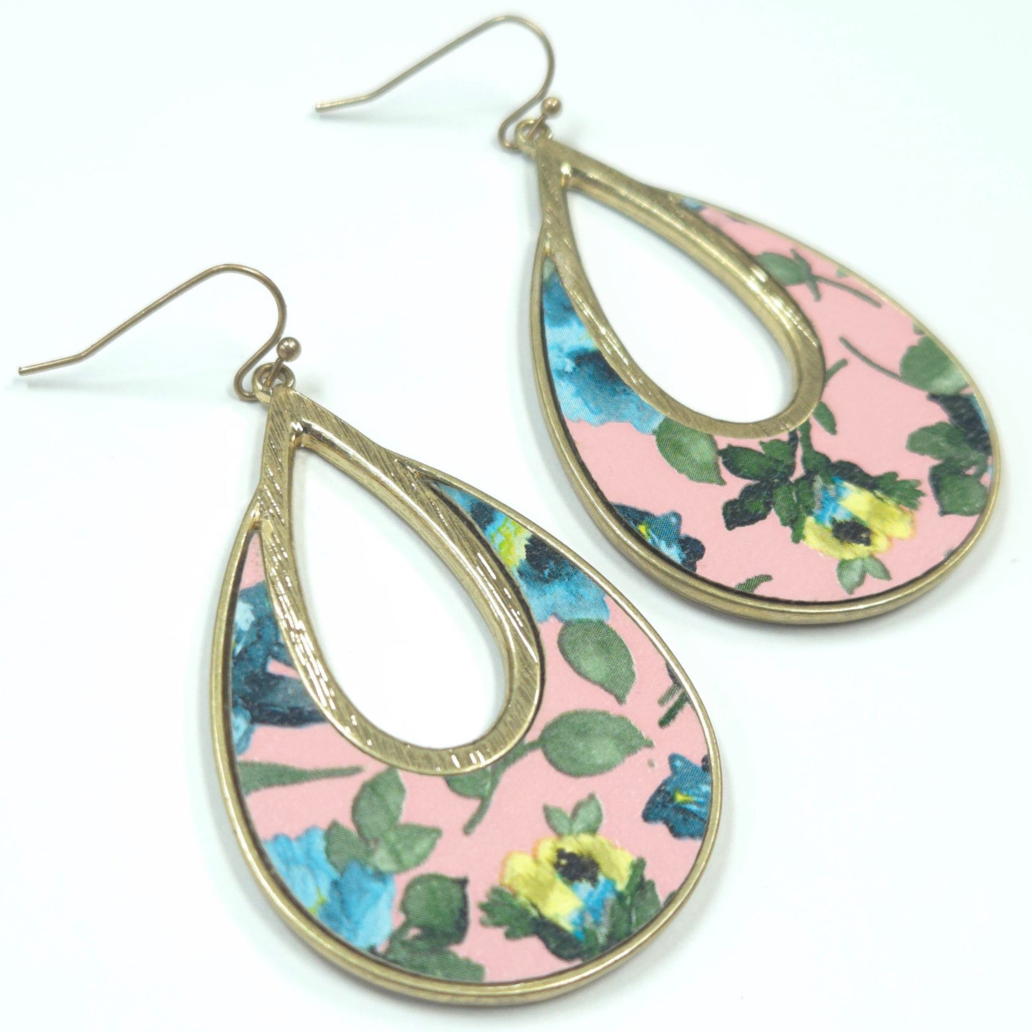 Teardrop-shaped earrings with floral design on a pink background
