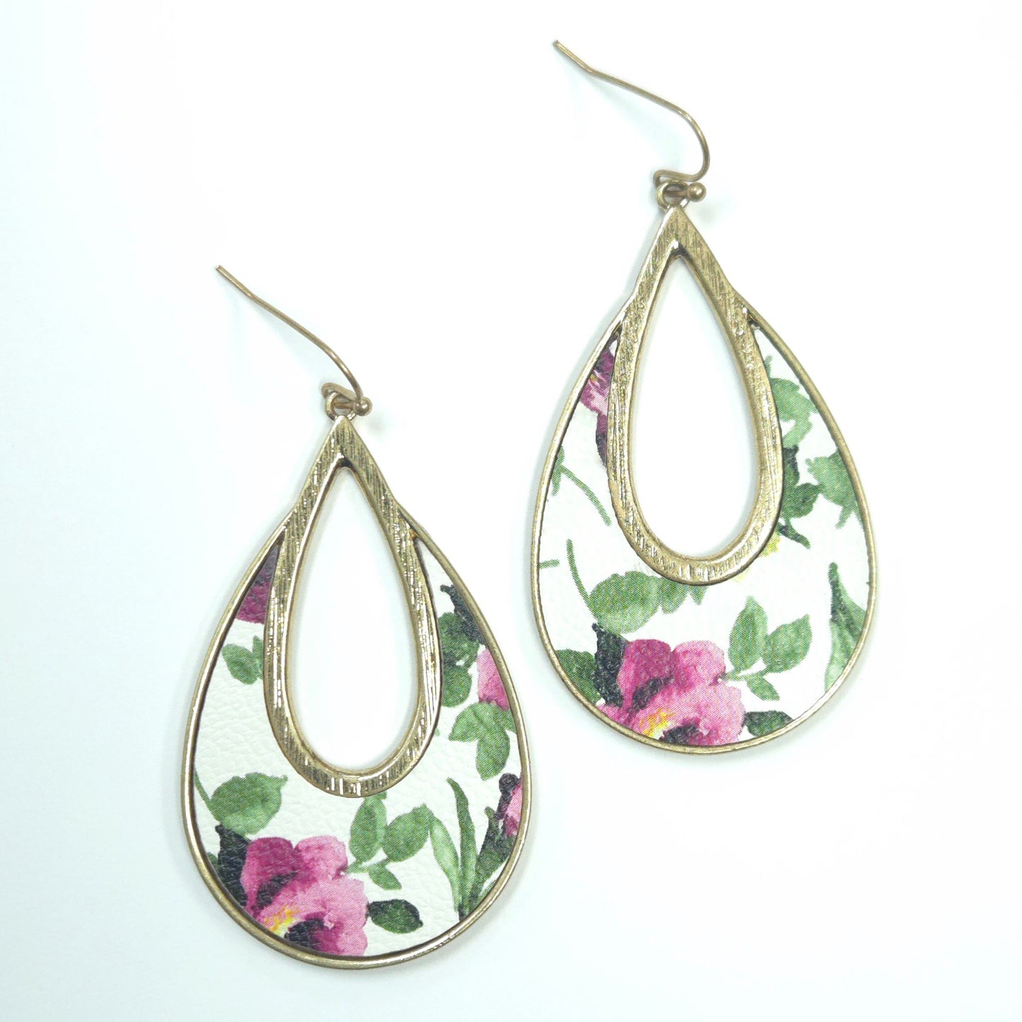 Teardrop-shaped earrings with floral design on a white background