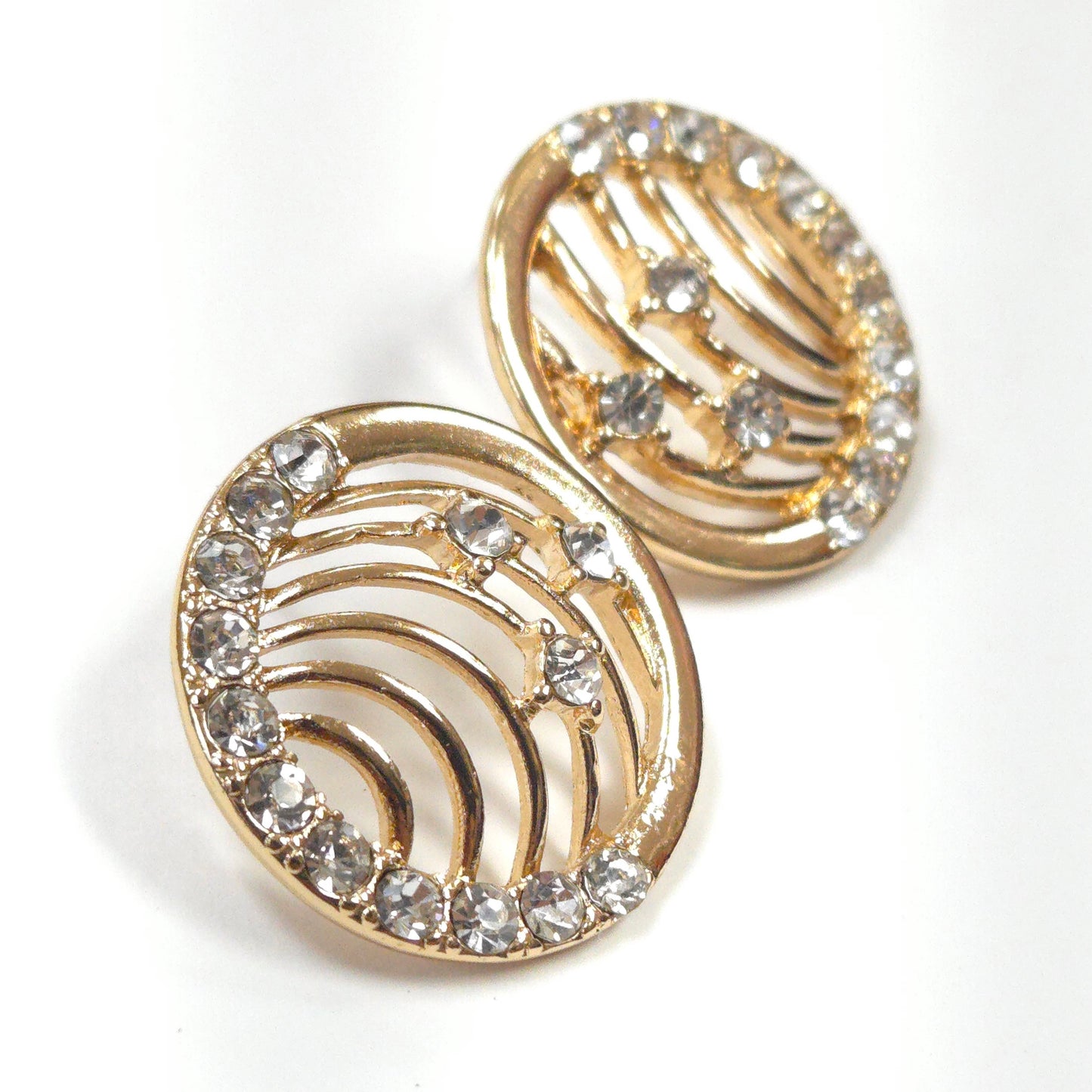 Gold earrings with crystal embellishments on a white background