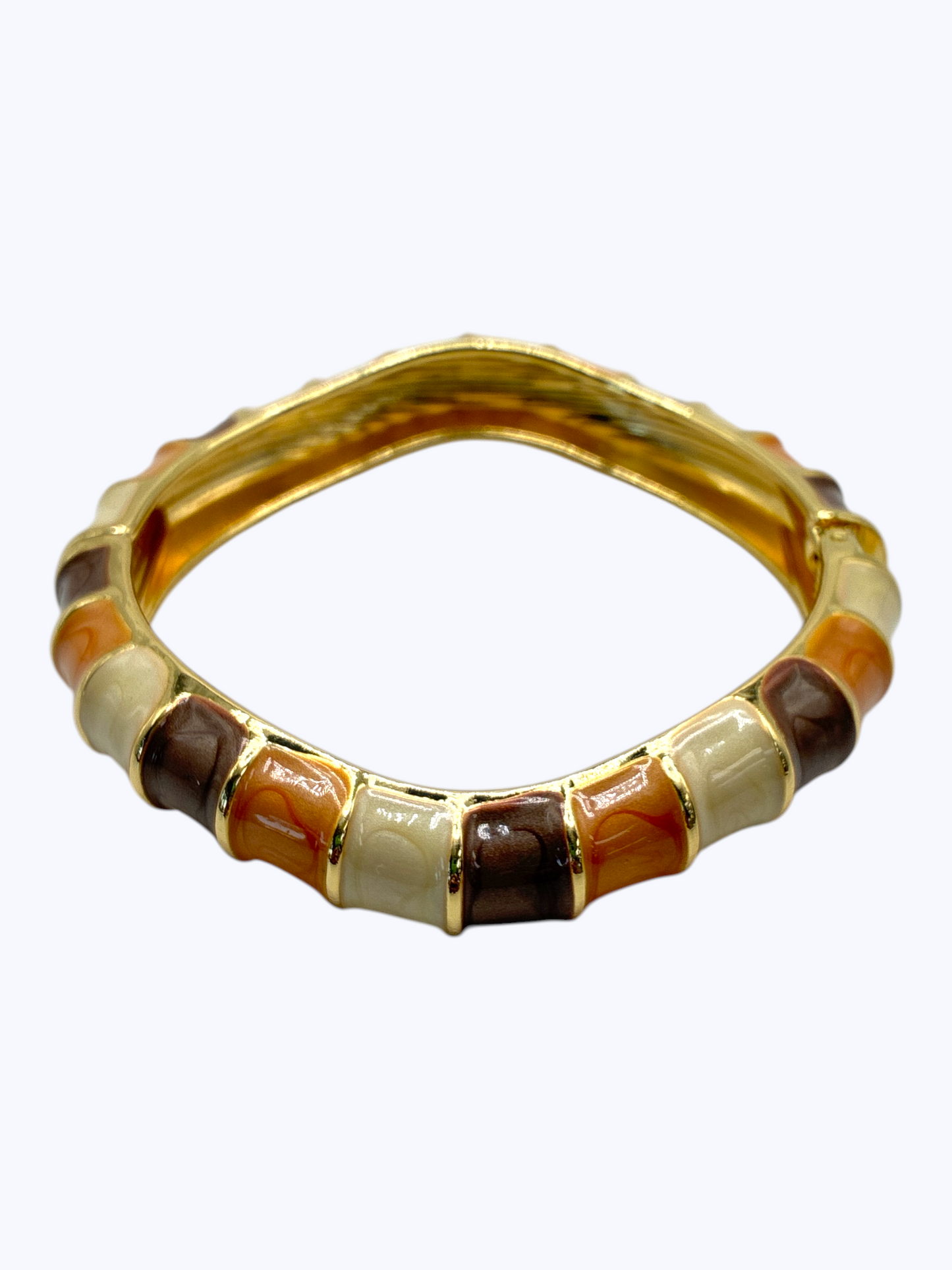 Gold ring with embedded stones on a white background