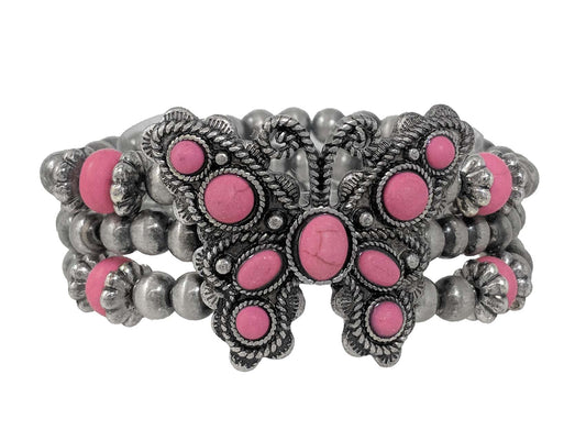 Western-inspired butterfly stretch bracelet with ornate antique silver detailing, pink stone accents, and layered metallic beads.