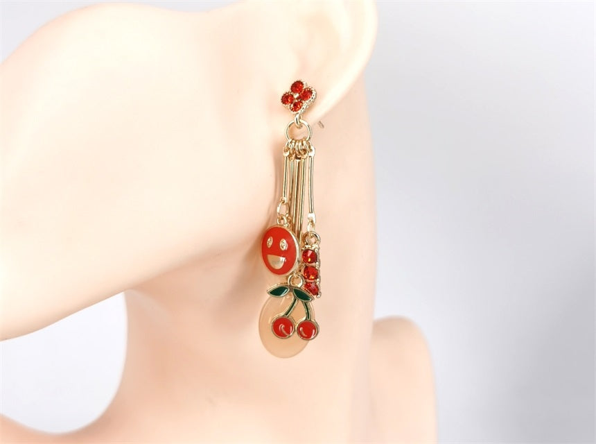 Cherry-themed earrings on a mannequin ear with a plain background