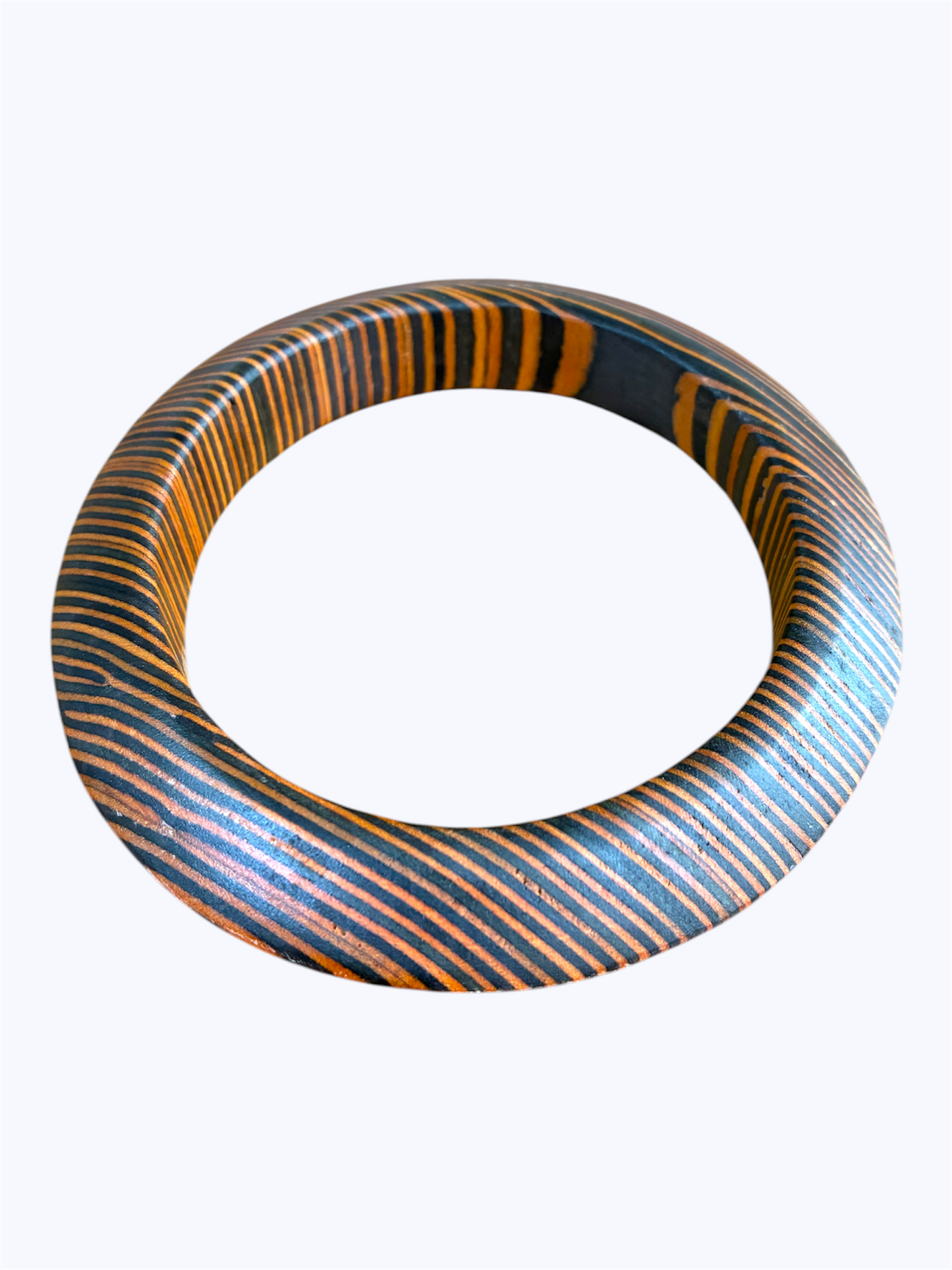 Blue wood grain oval bangle bracelet with striped detailing and a modern sculpted resin design