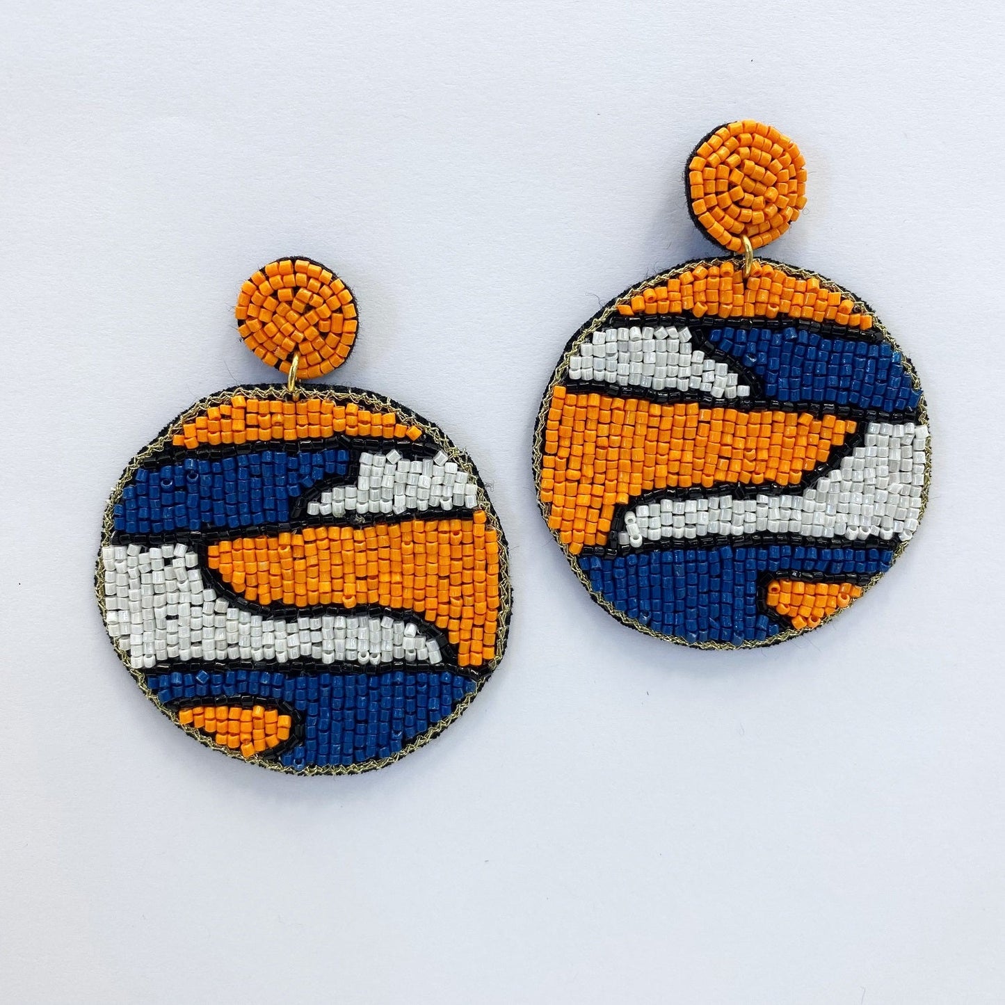 A pair of beaded earrings on a white background