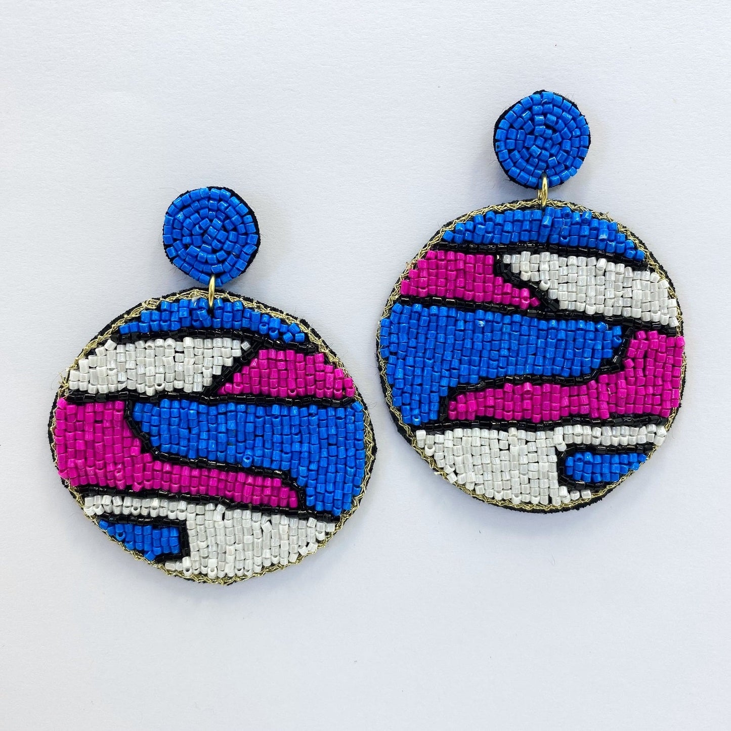 A pair of beaded earrings on a white background