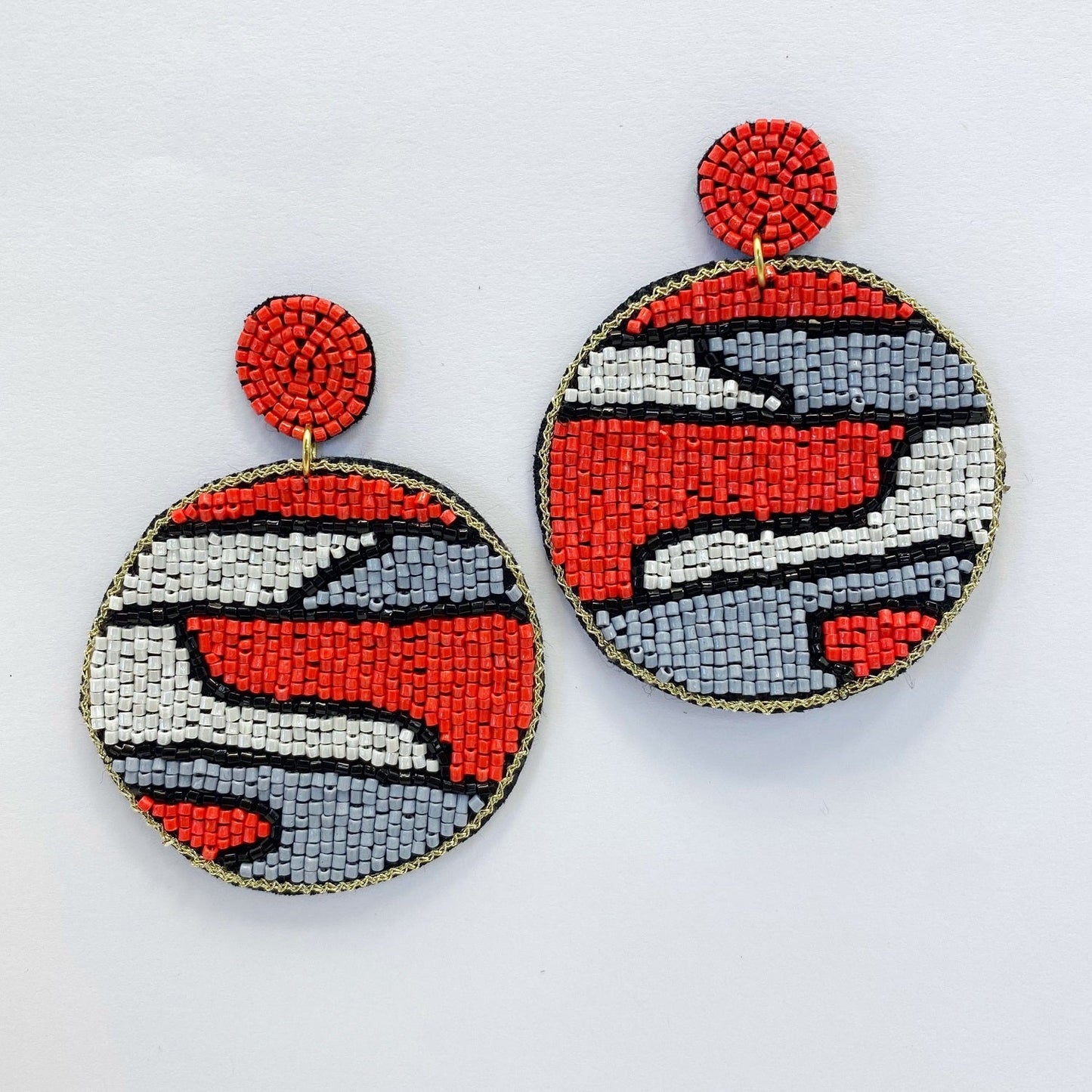 A pair of beaded earrings on a white background