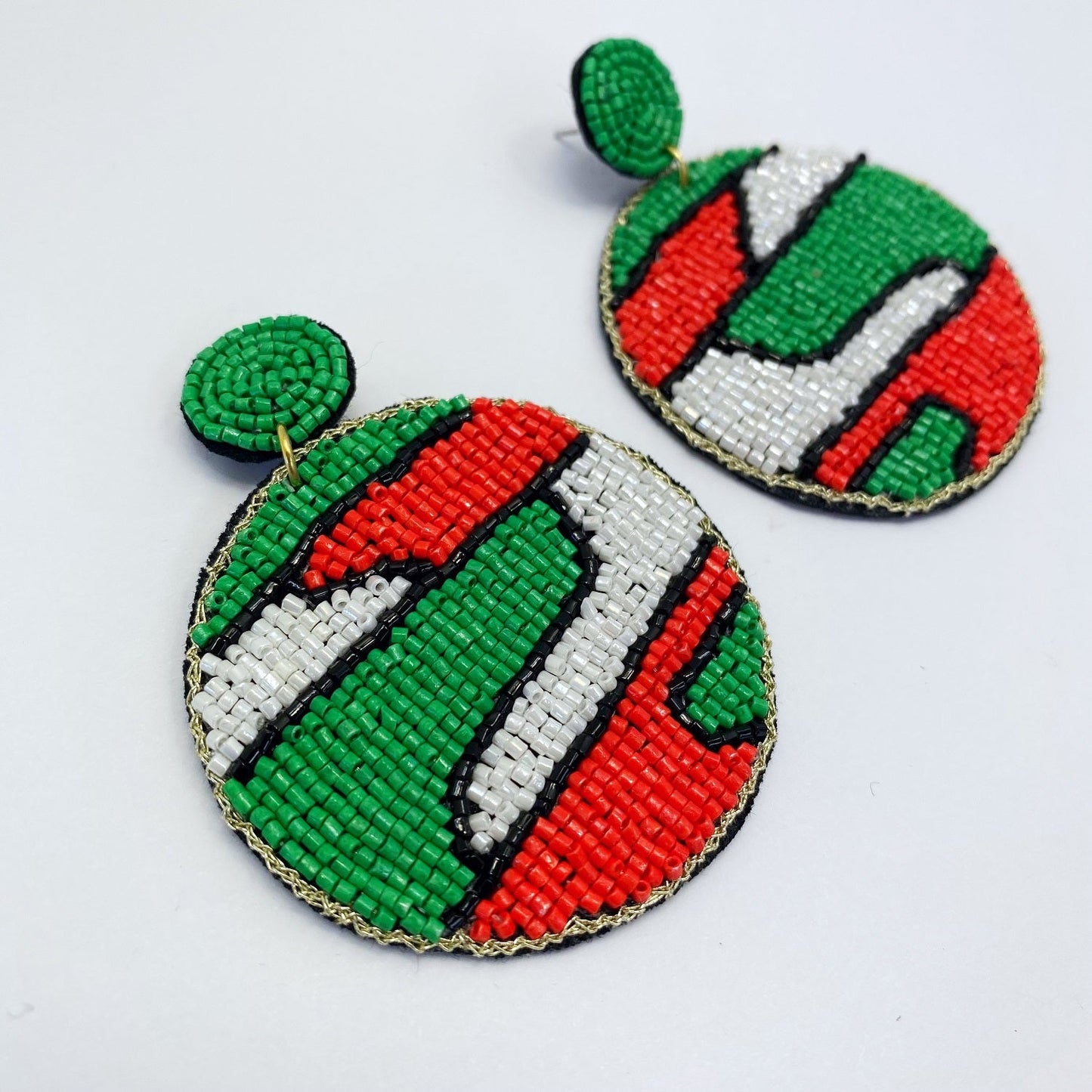 A pair of beaded earrings on a white background