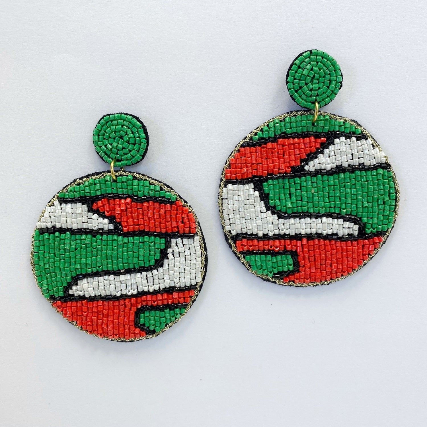 A pair of beaded earrings on a white background