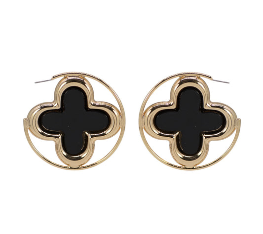 Pair of gold earrings with black clover-like centers on a white background