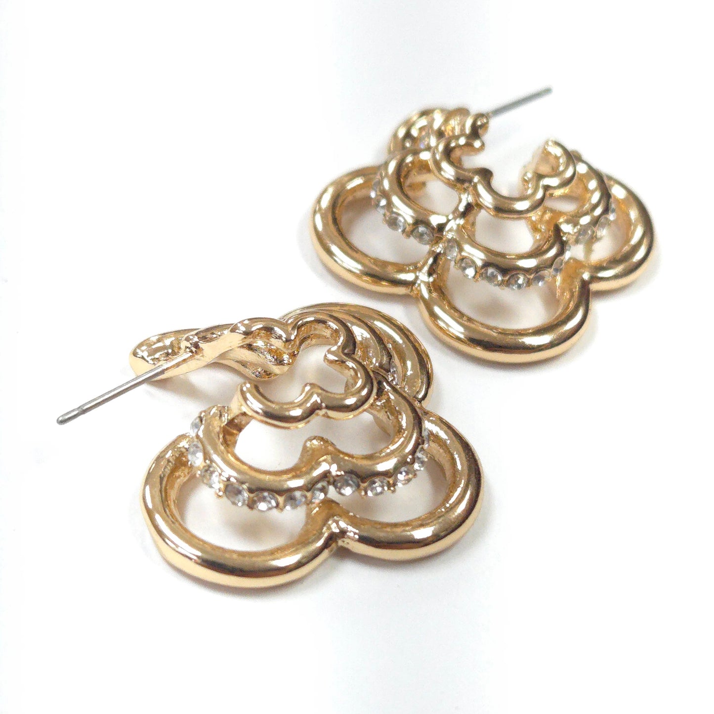 Gold hoop earrings with diamond-like stones on a white background