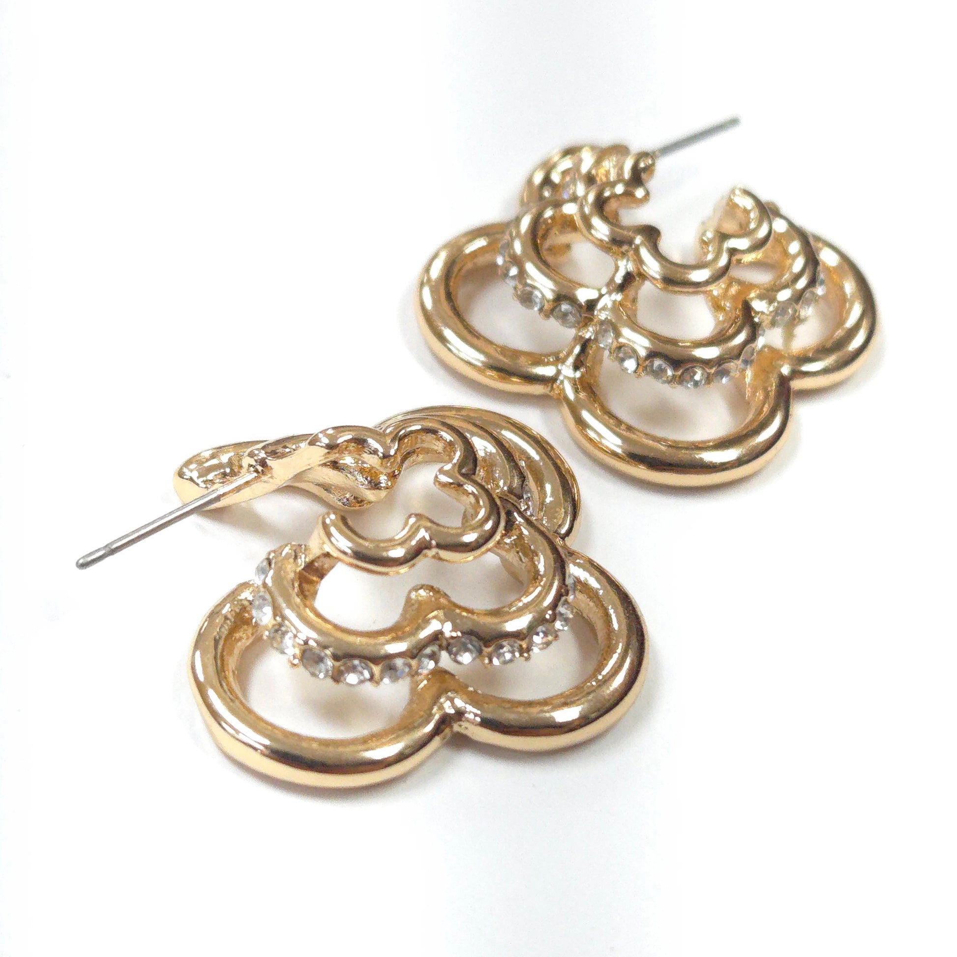 Gold hoop earrings with diamond-like stones on a white background