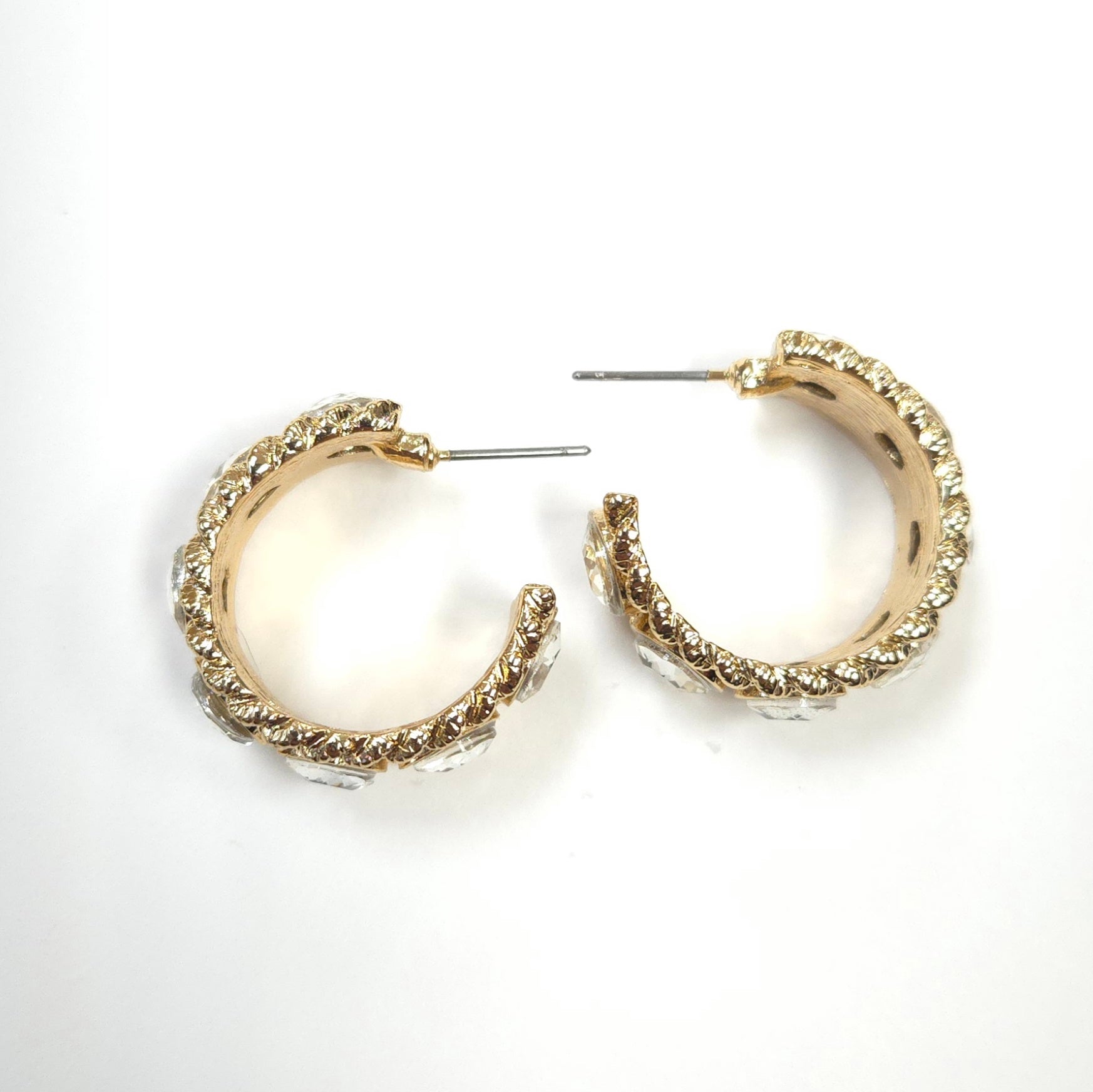 Gold hoop earrings on a white background