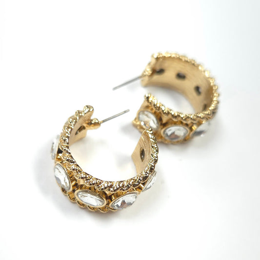 Gold hoop earrings with embedded stones on a white background