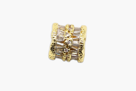 Gold and crystal beaded charm on a white background