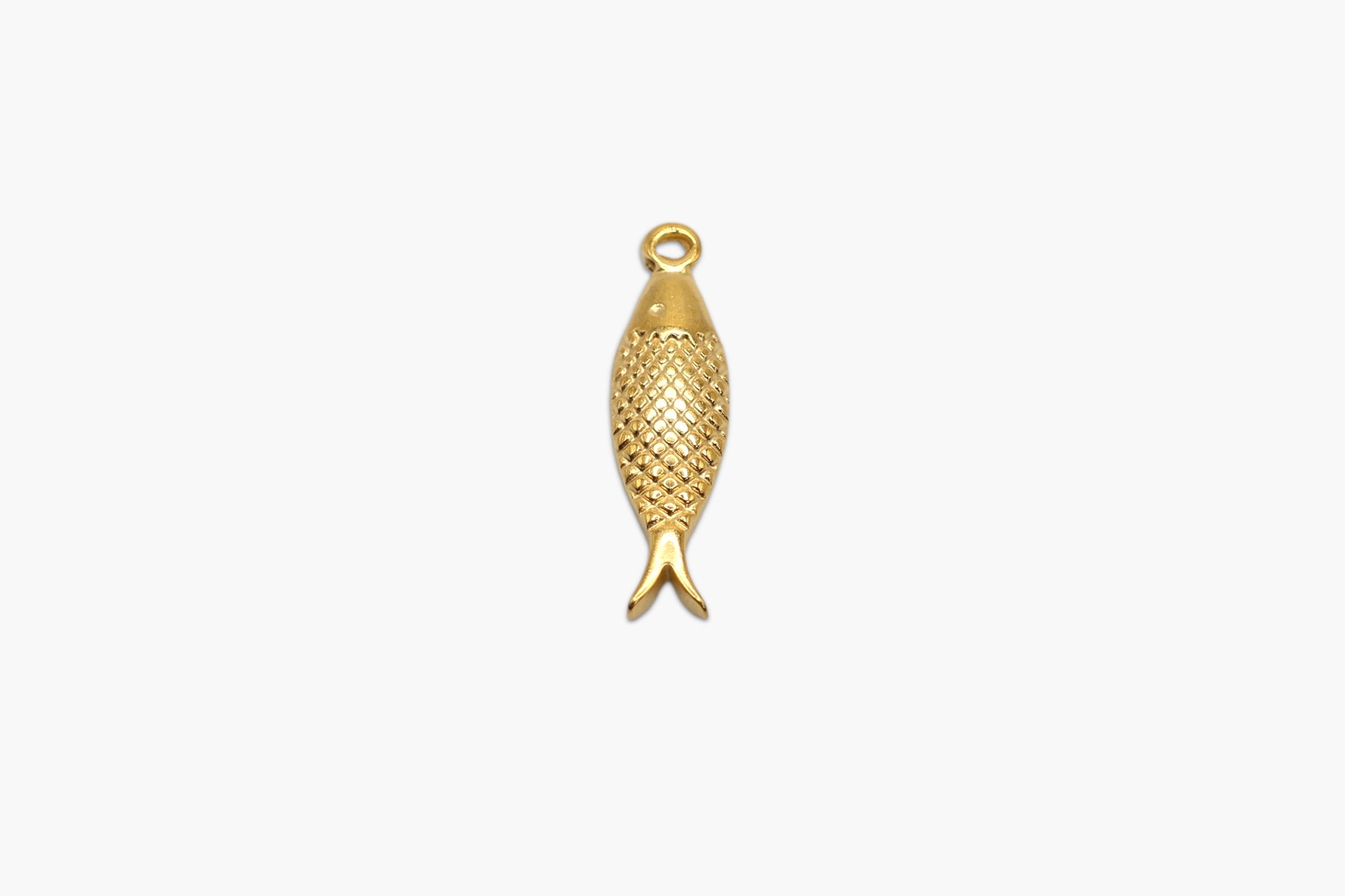 Gold fish-shaped pendant on a white background