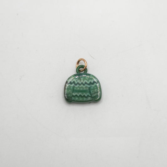 Green ceramic charm with gold loop on a white background