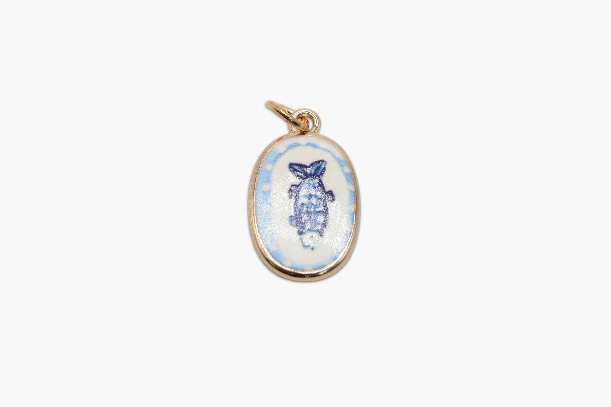 Gold pendant with a blue and white design on a white background